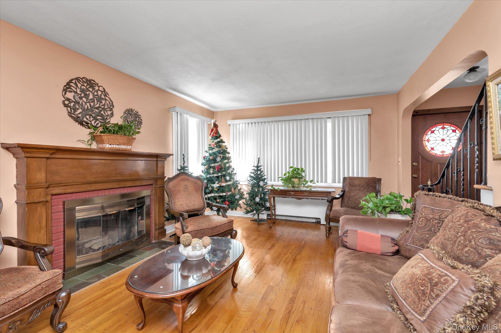 89 Foster Avenue Valley Stream, NY 11580 - Photo 4 of 20 Living room featuring hardwood floors and fireplace