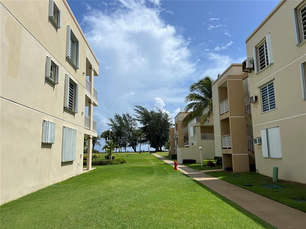 968 Camino Las Picüas, Unit 30 Rio Grande, Río Grande 00745 - Photo 21 of 24 a view of an apartment building with a yard