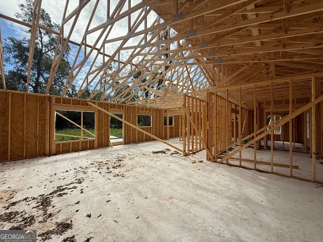 a view of house with backyard and seating area