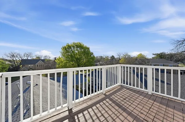 a balcony with wooden floor and fence