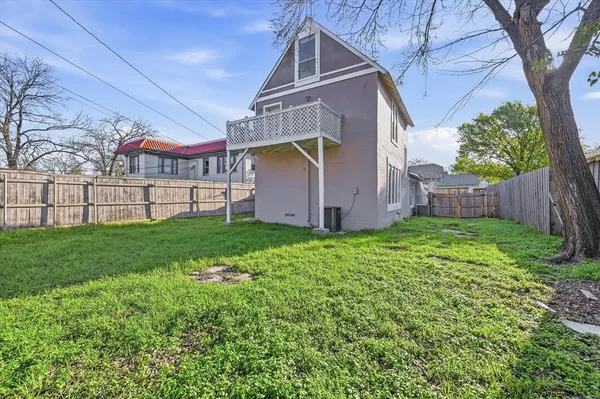 a view of a house with a yard and sitting area
