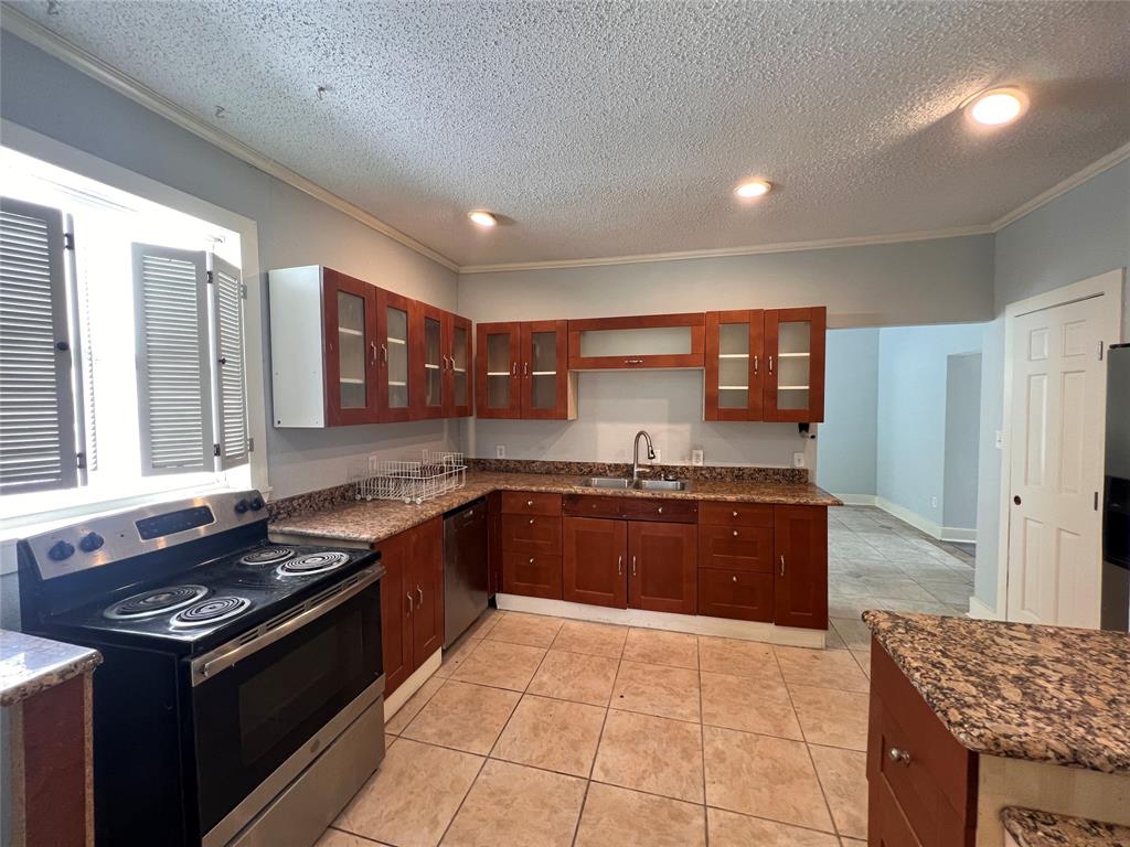 843 North Clinton Avenue Dallas, TX 75208 - Photo 4 of 8 a large kitchen with stainless steel appliances granite countertop a stove and a sink