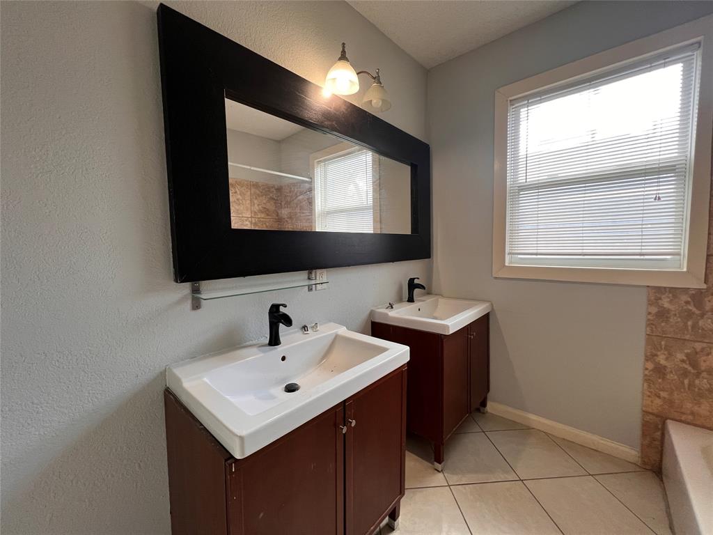 843 North Clinton Avenue Dallas, TX 75208 - Photo 6 of 8 a bathroom with a sink and a mirror