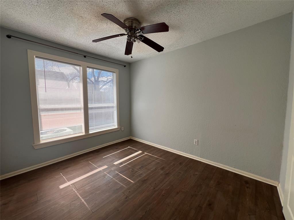 843 North Clinton Avenue Dallas, TX 75208 - Photo 8 of 8 en empty room with windows and ceiling fan