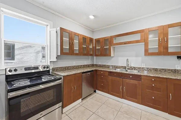 a kitchen with a sink stove and cabinets