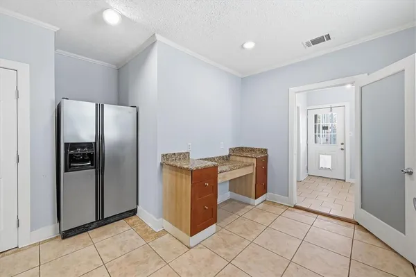 a kitchen with stainless steel appliances granite countertop a refrigerator and a stove