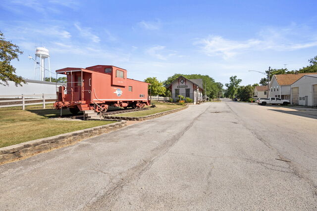 648 Penfield Street Beecher, IL 60401 - Photo 11 of 15 a sign board with a big yard and a large buildings