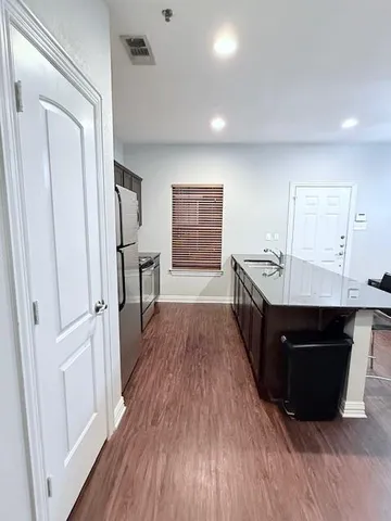 a kitchen with a stove refrigerator and microwave