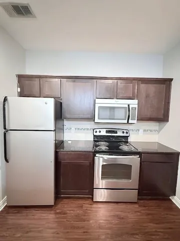 a kitchen with center island and stainless steel appliances