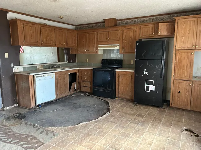 a kitchen with a refrigerator stove and a sink