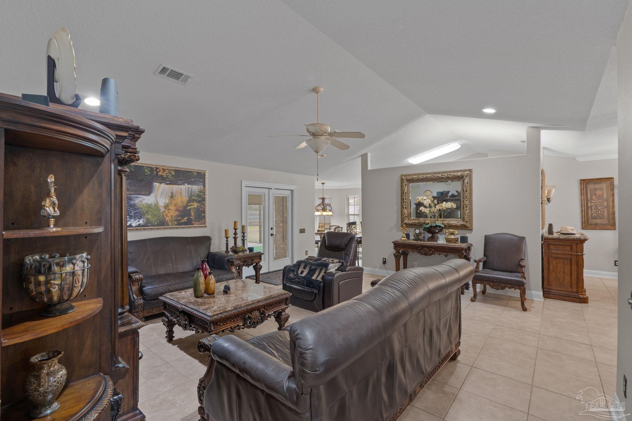 5692 Als Way Milton, FL 32583 - Photo 14 of 68 a living room with fireplace furniture and a flat screen tv