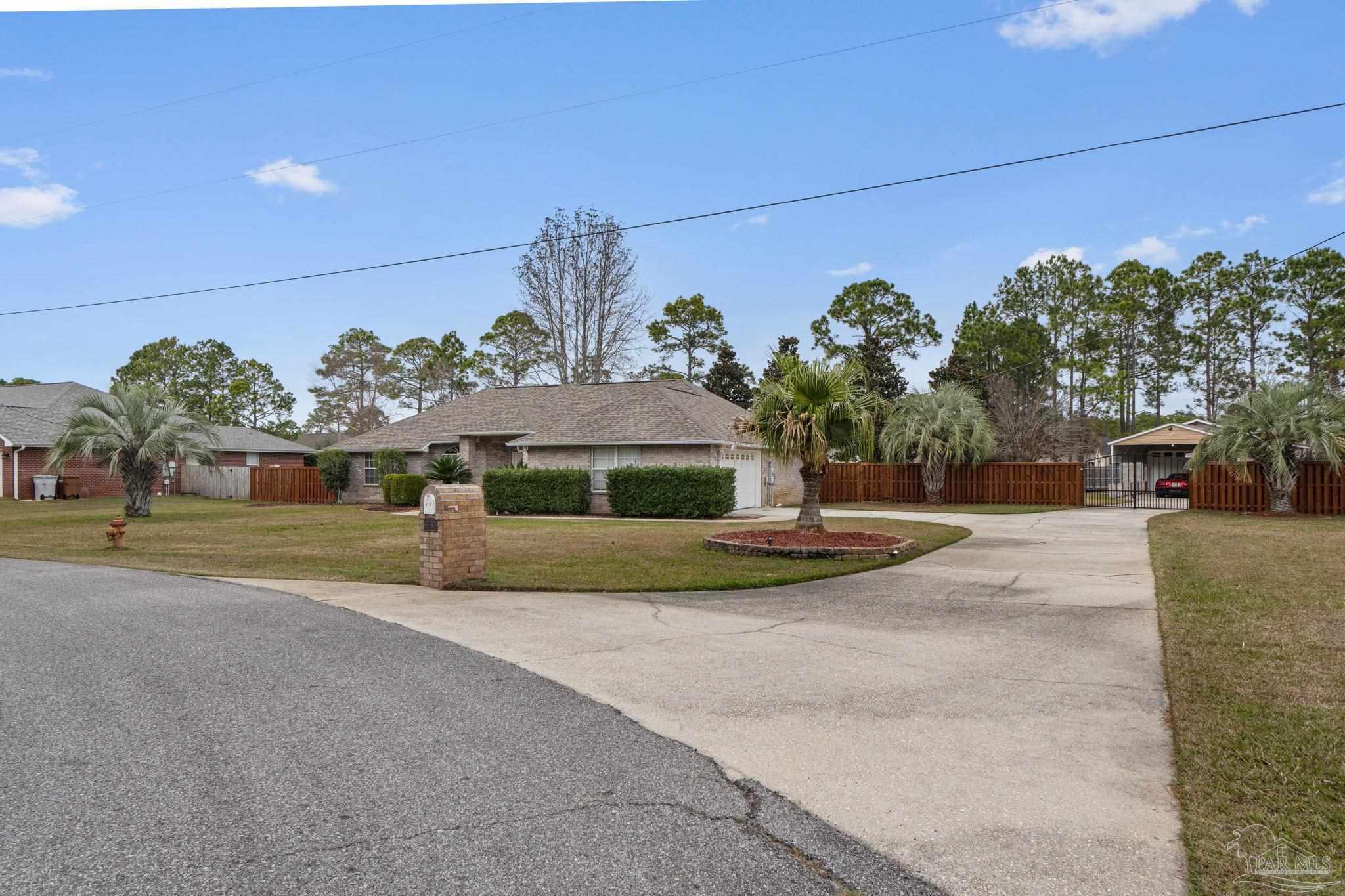 5692 Als Way Milton, FL 32583 - Photo 2 of 68 a view of a house with a yard and potted plants