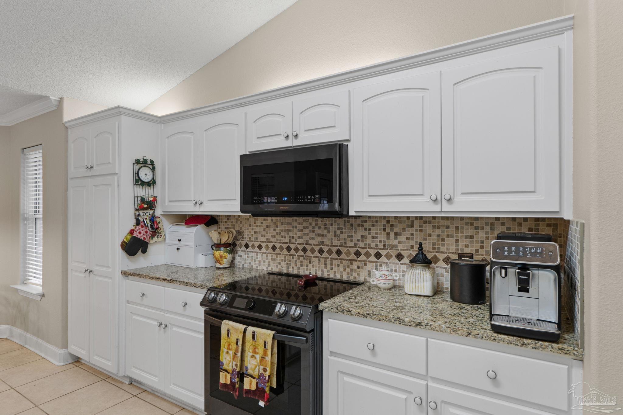 5692 Als Way Milton, FL 32583 - Photo 21 of 68 a kitchen with stainless steel appliances granite countertop white cabinets and a stove