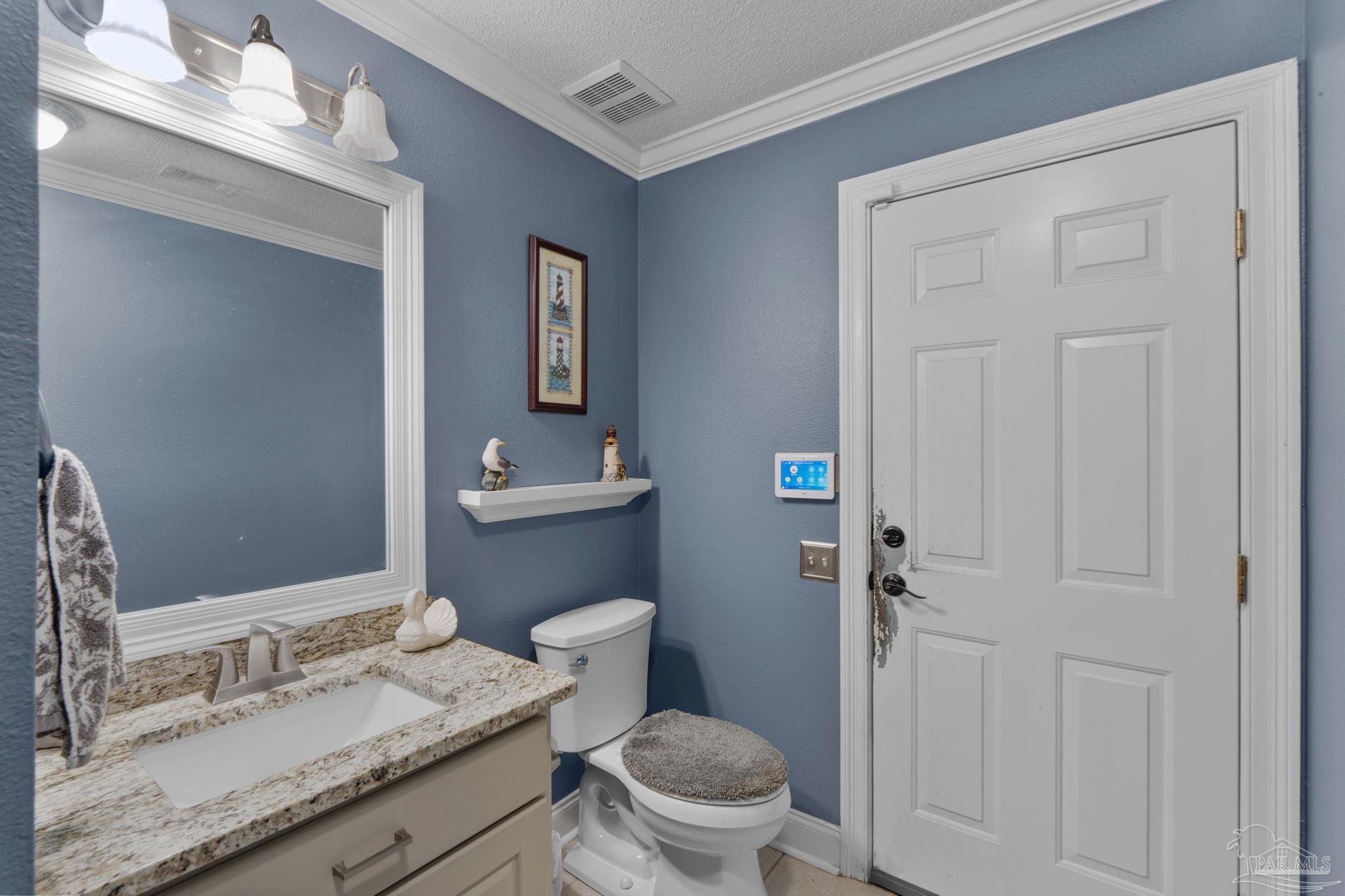 5692 Als Way Milton, FL 32583 - Photo 22 of 68 a bathroom with a granite countertop toilet sink and mirror