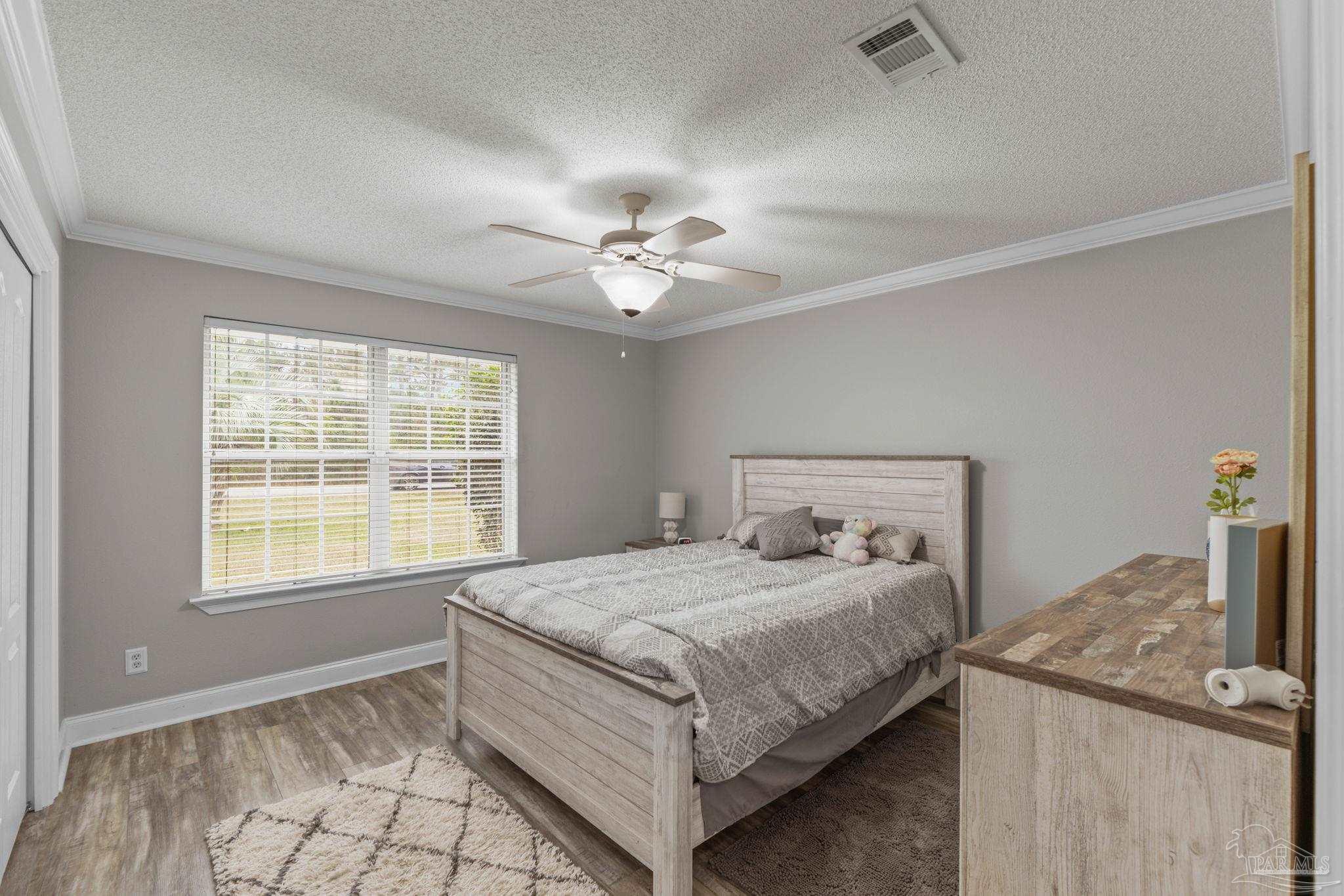 5692 Als Way Milton, FL 32583 - Photo 28 of 68 a bedroom with a bed and a table