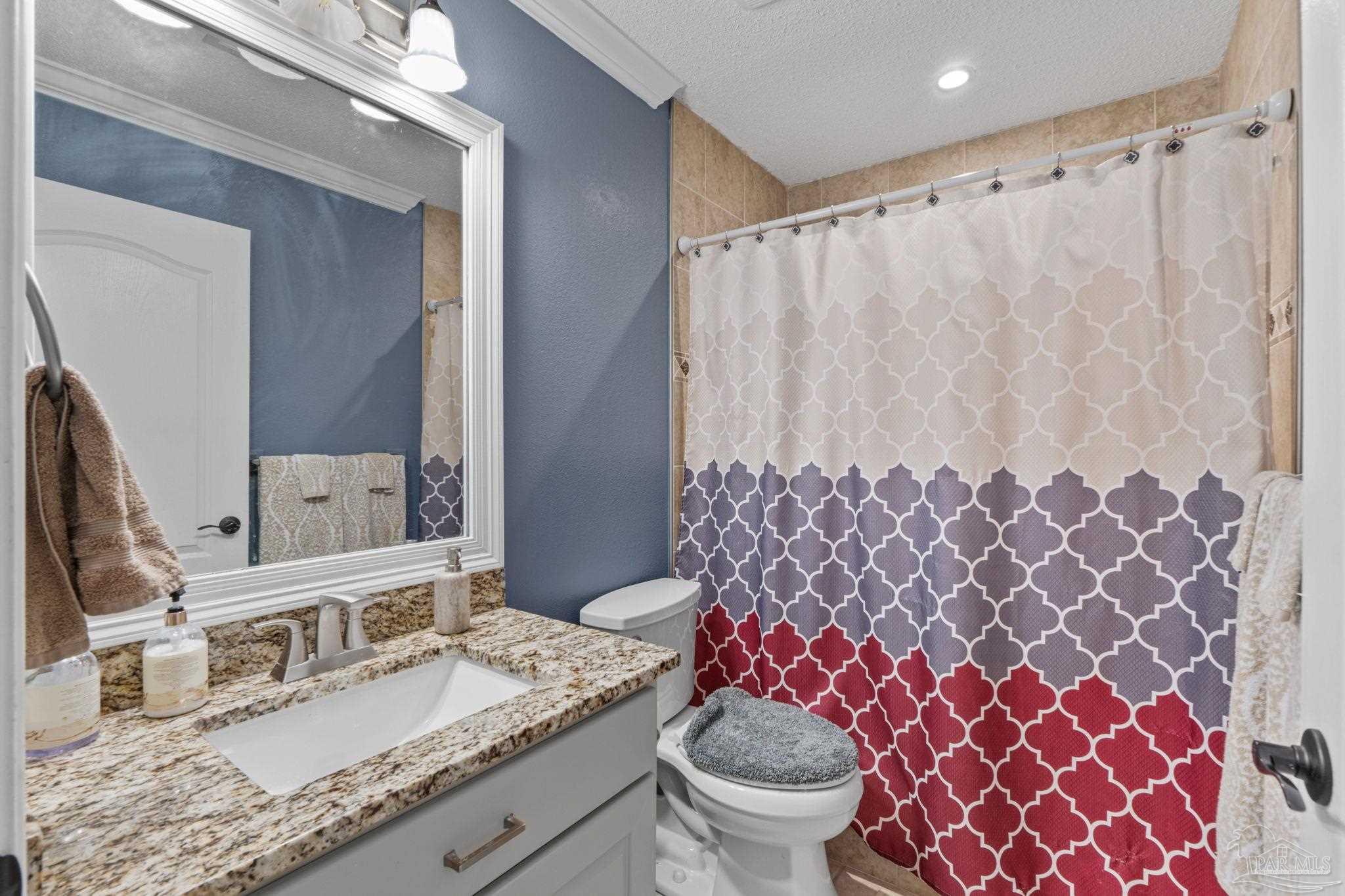 5692 Als Way Milton, FL 32583 - Photo 29 of 68 a bathroom with a granite countertop sink and a mirror