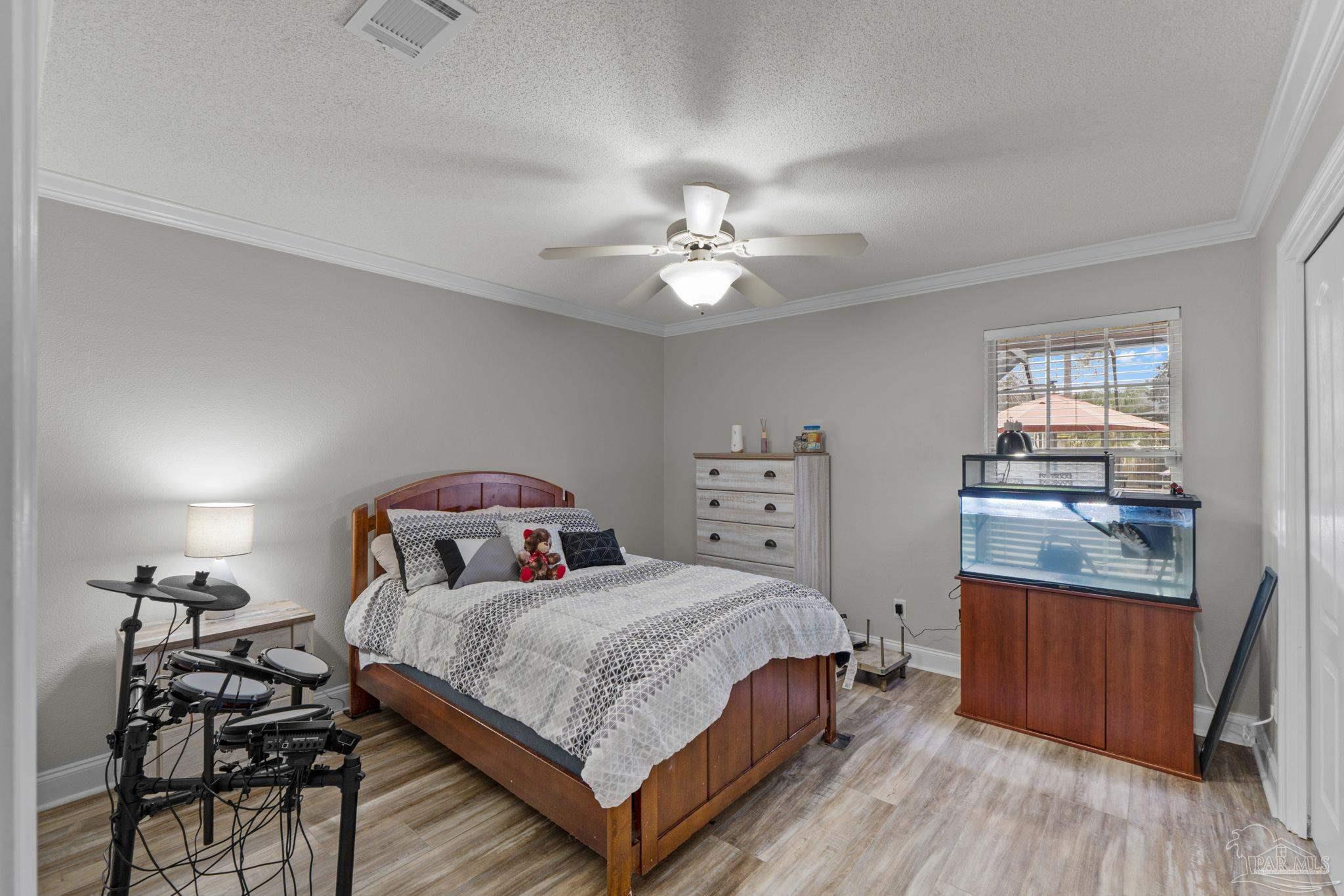 5692 Als Way Milton, FL 32583 - Photo 30 of 68 a bedroom with a bed and wooden floor