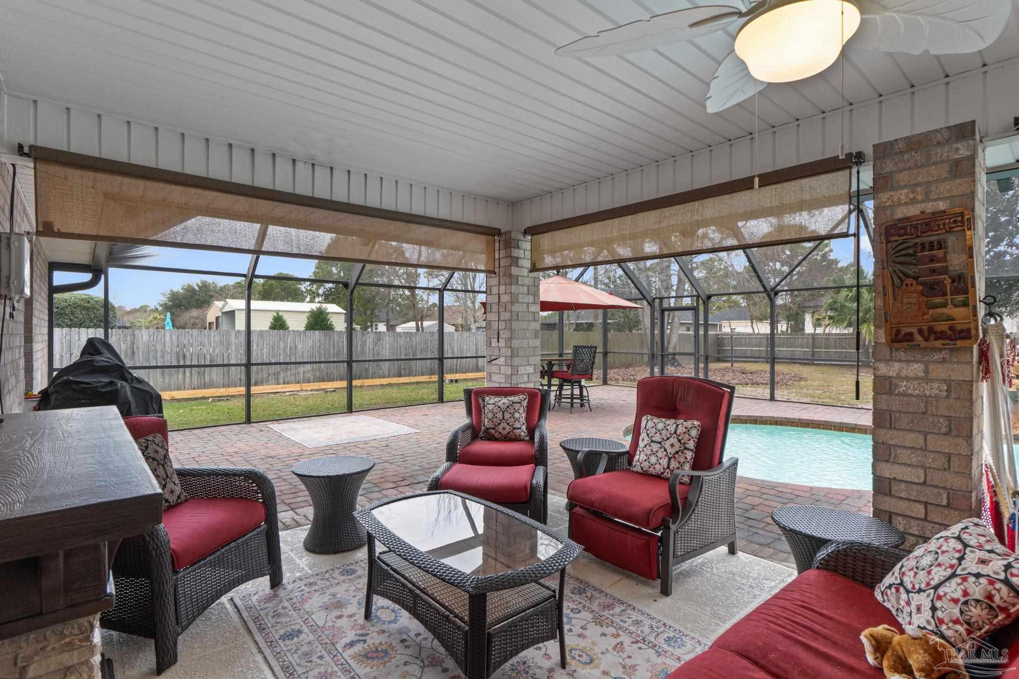 5692 Als Way Milton, FL 32583 - Photo 32 of 68 a outdoor living space with furniture and a floor to ceiling window