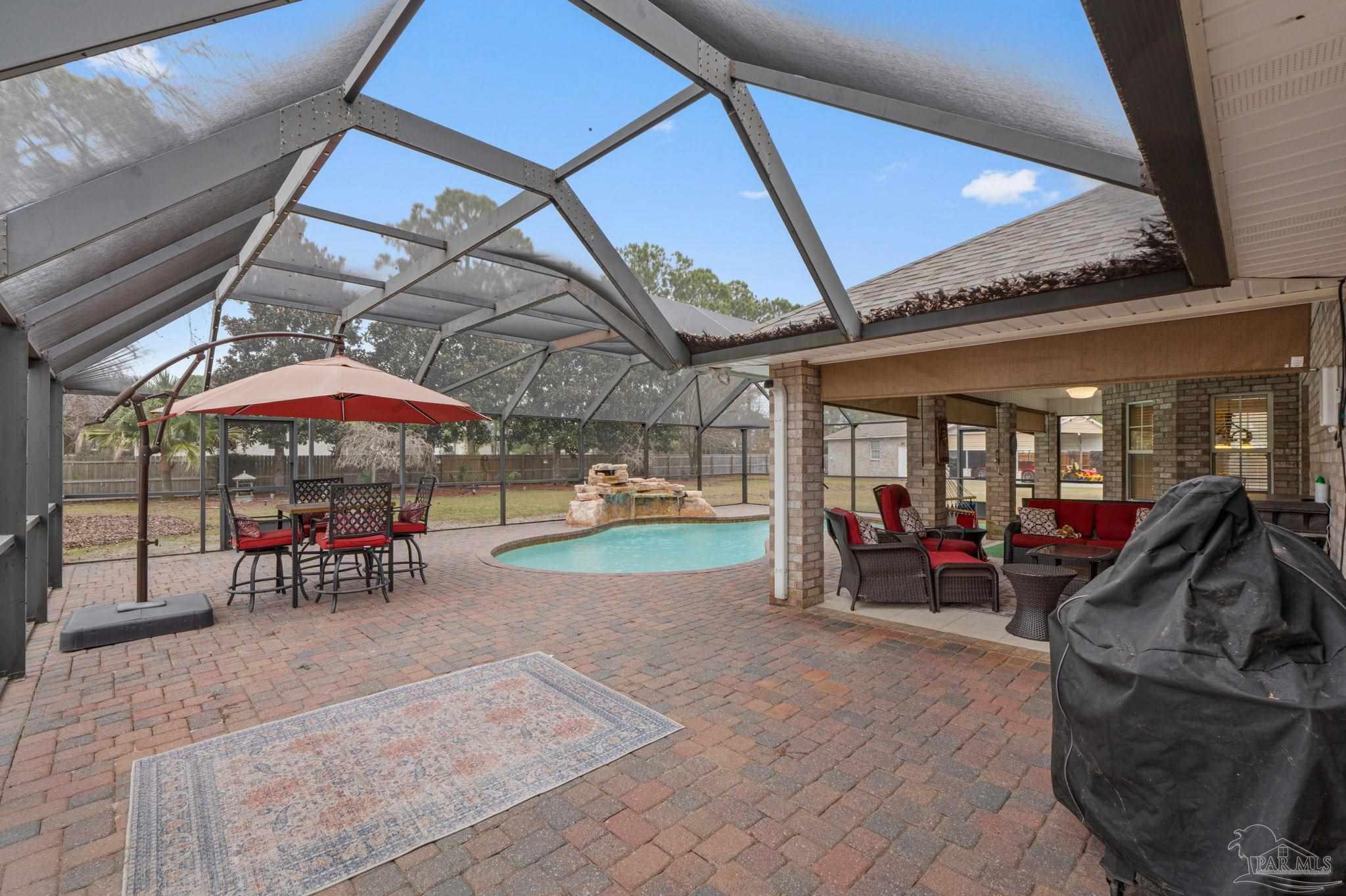 5692 Als Way Milton, FL 32583 - Photo 33 of 68 a view of a chairs and table in patio with a barbeque