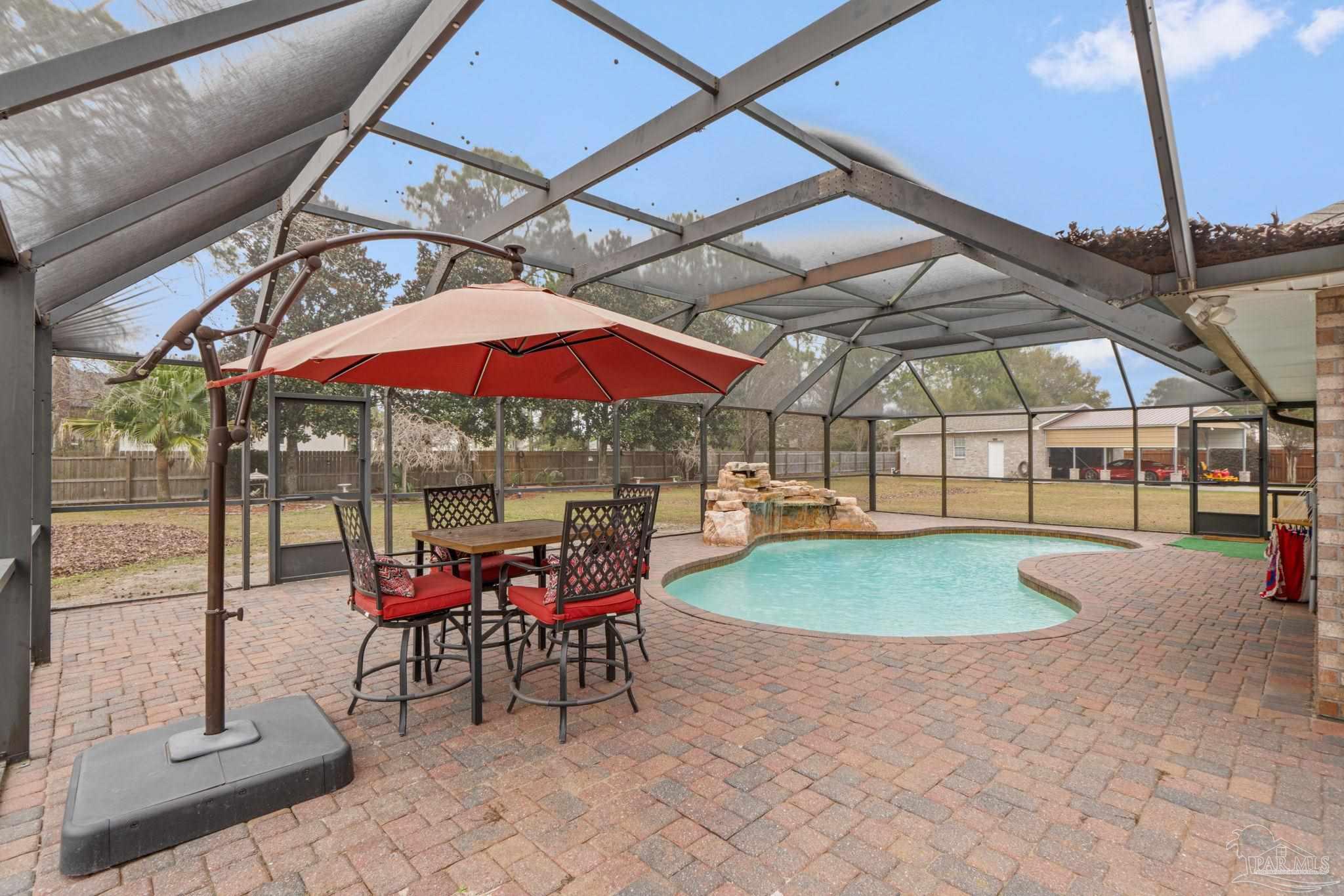 5692 Als Way Milton, FL 32583 - Photo 34 of 68 a patio with a patio table and chairs