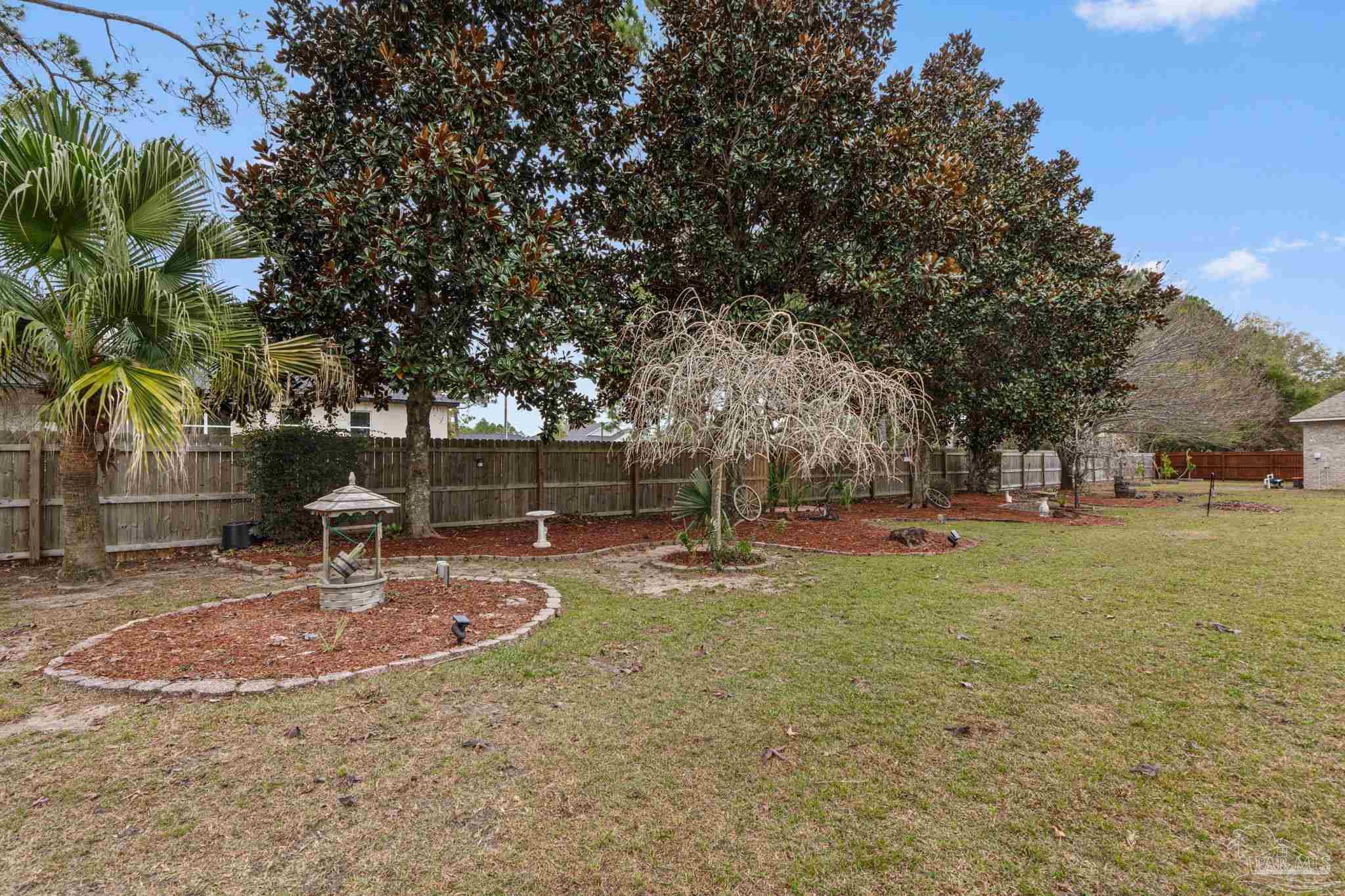 5692 Als Way Milton, FL 32583 - Photo 41 of 68 a backyard of a house with table and chairs