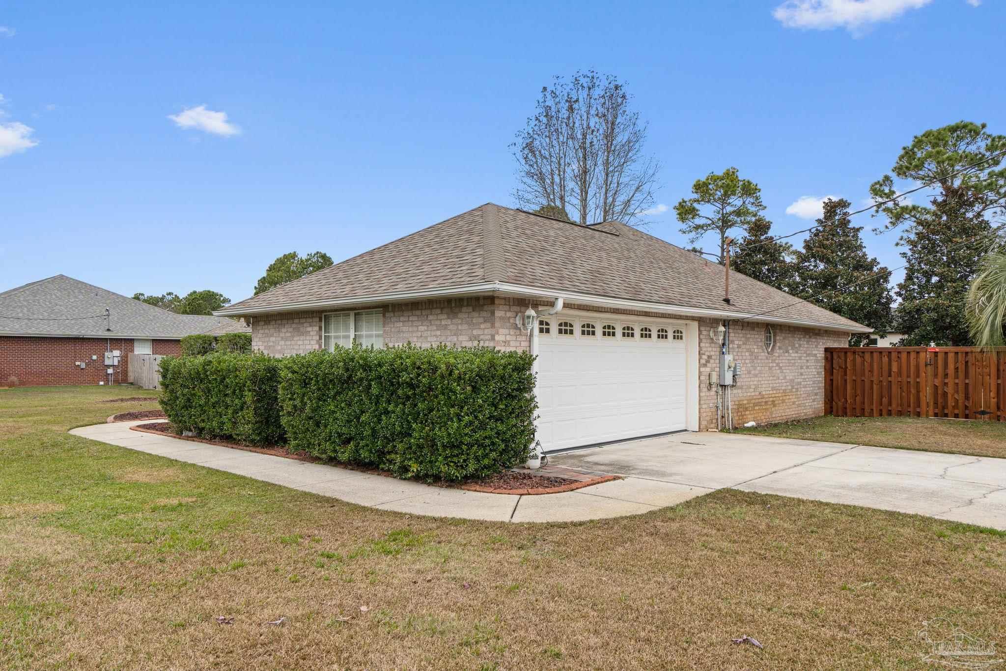 5692 Als Way Milton, FL 32583 - Photo 5 of 68 a view of a house with a yard and potted plants