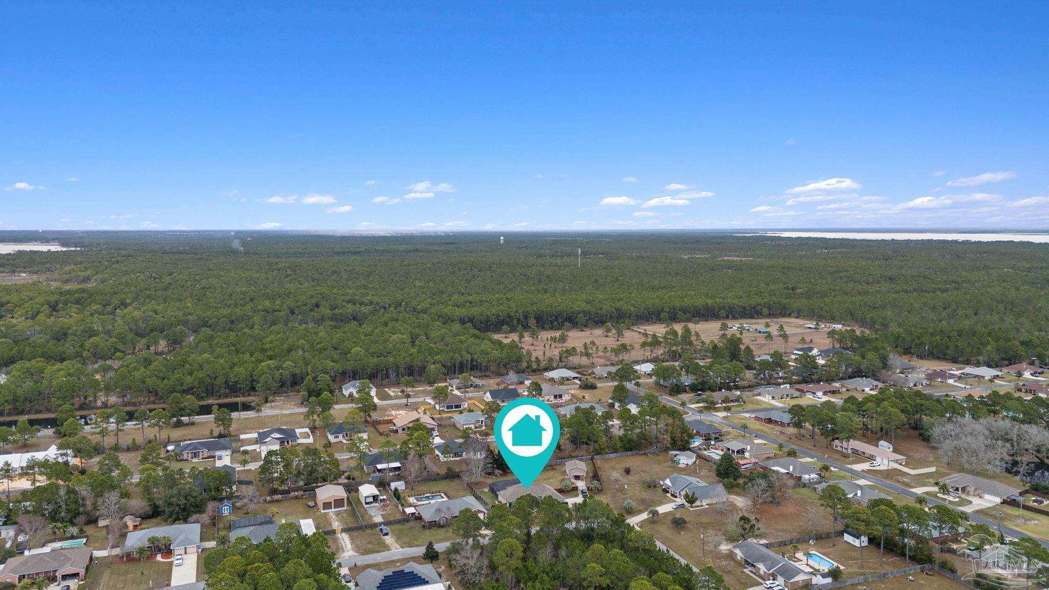 5692 Als Way Milton, FL 32583 - Photo 53 of 68 a view of a golf course with a lake