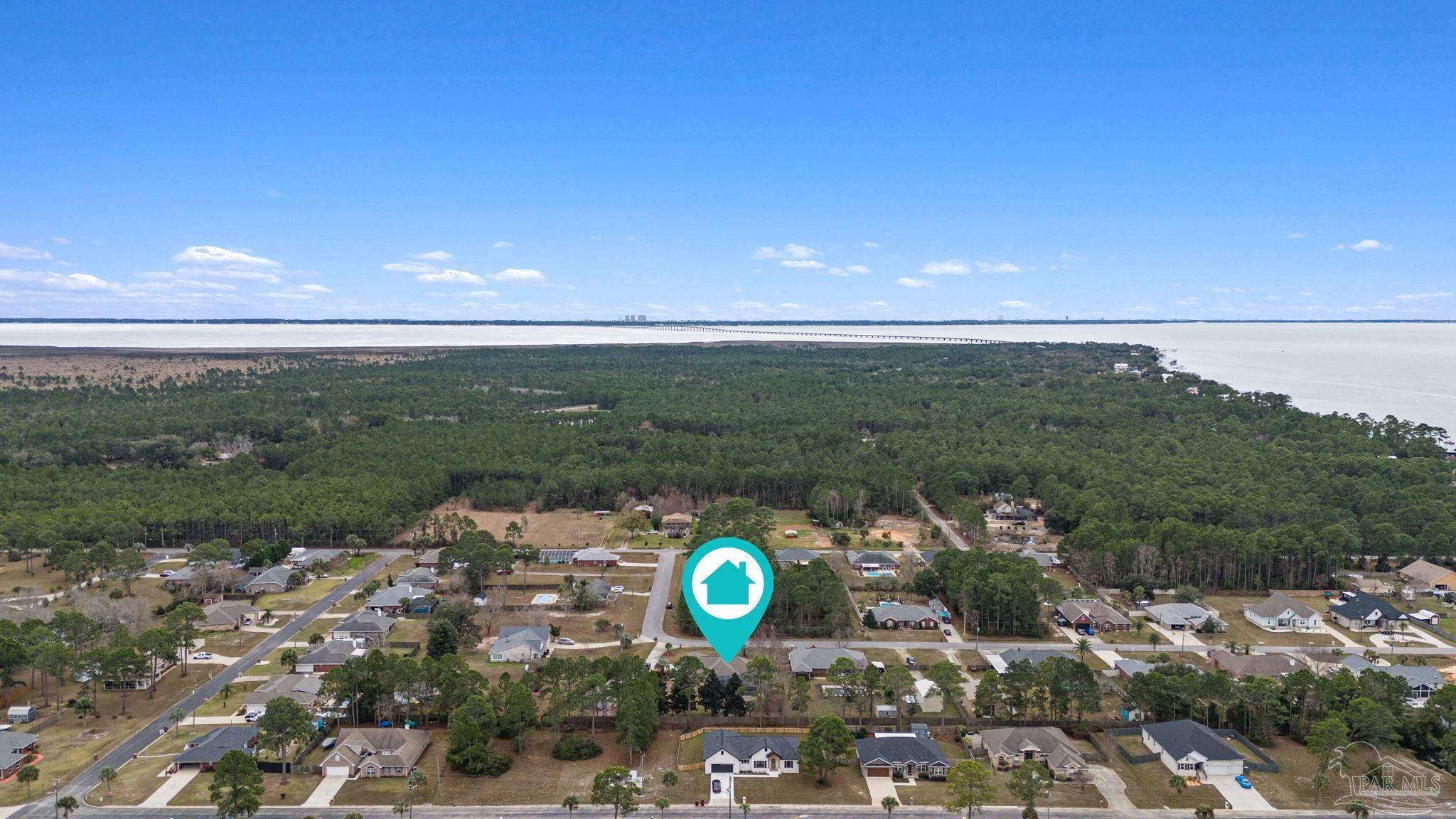 5692 Als Way Milton, FL 32583 - Photo 57 of 68 a view of a golf course with a lake