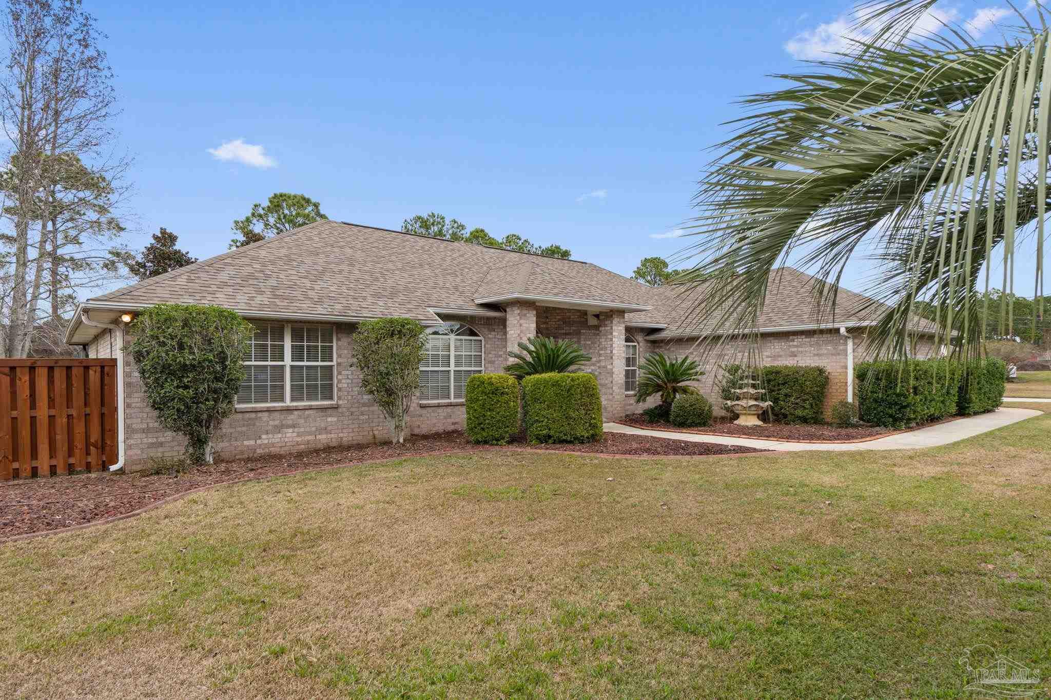 5692 Als Way Milton, FL 32583 - Photo 7 of 68 a view of a house with a yard and potted plants