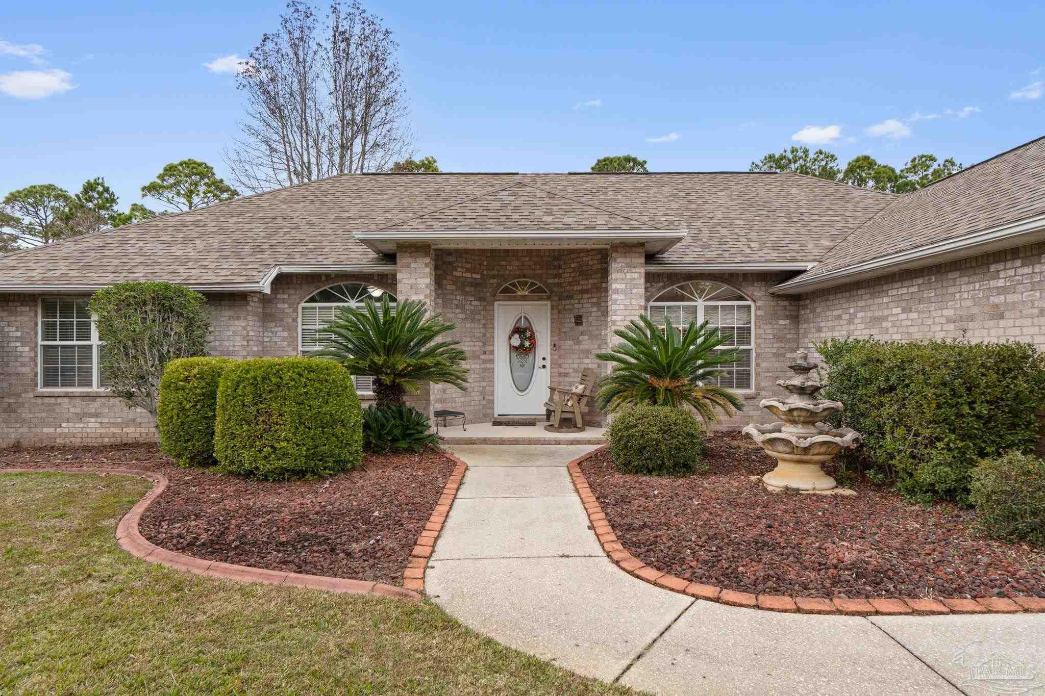 5692 Als Way Milton, FL 32583 - Photo 8 of 68 a front view of a house with garden