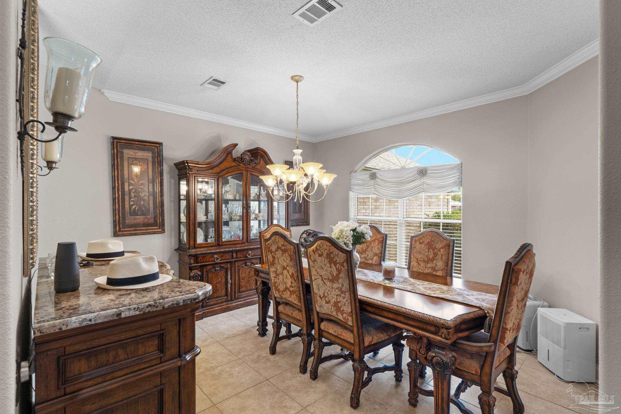 5692 Als Way Milton, FL 32583 - Photo 10 of 68 a view of a dining room with furniture and chandelier