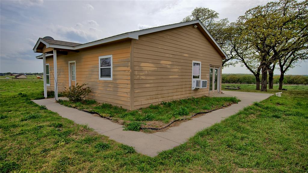 688 Alamo Road Montague, TX 76251 - Photo 2 of 35 a front view of a house with garden