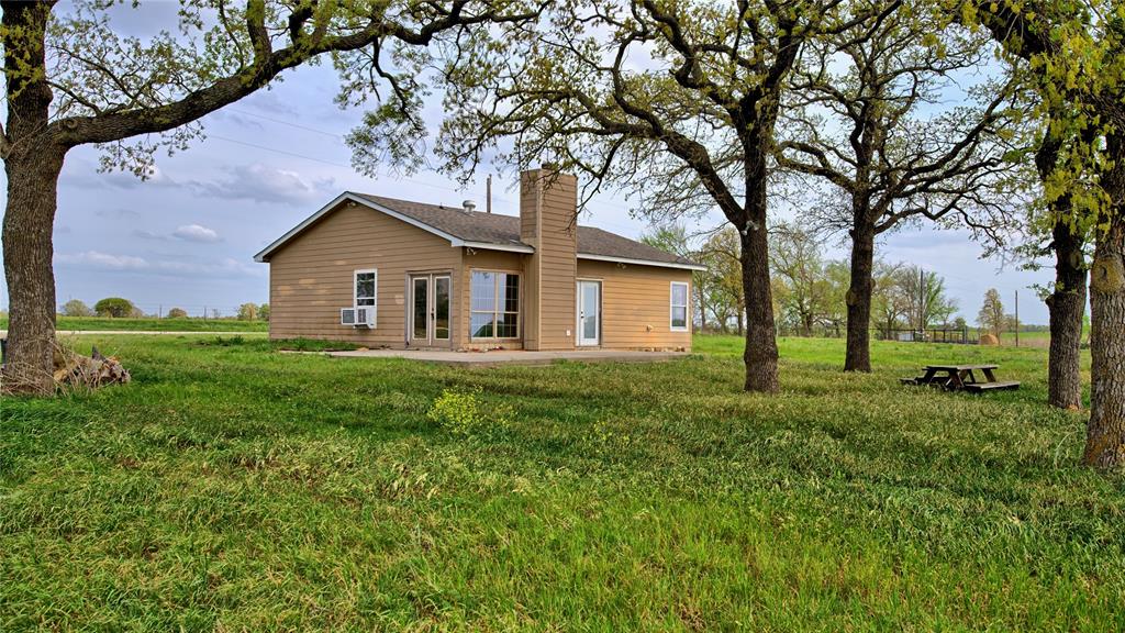 688 Alamo Road Montague, TX 76251 - Photo 7 of 35 a view of a house with yard and tree s