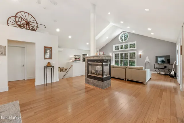 a living room with a couch and a dresser with wooden floor