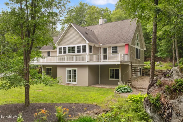 a view of a yard with wooden fence