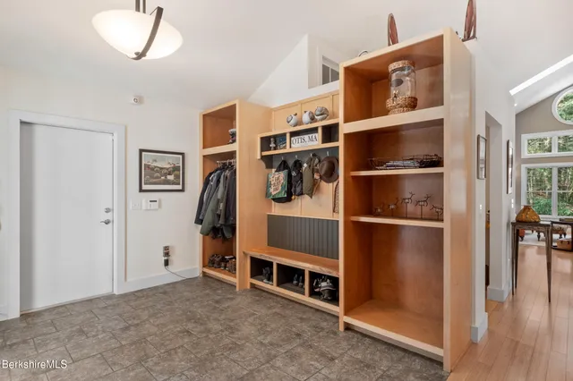 a kitchen with stainless steel appliances kitchen island granite countertop a stove a sink a refrigerator and chairs