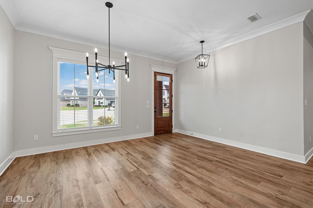 616 Meridian Way Benton, LA 71006 - Photo 12 of 40 a view of empty room with wooden floor and fan