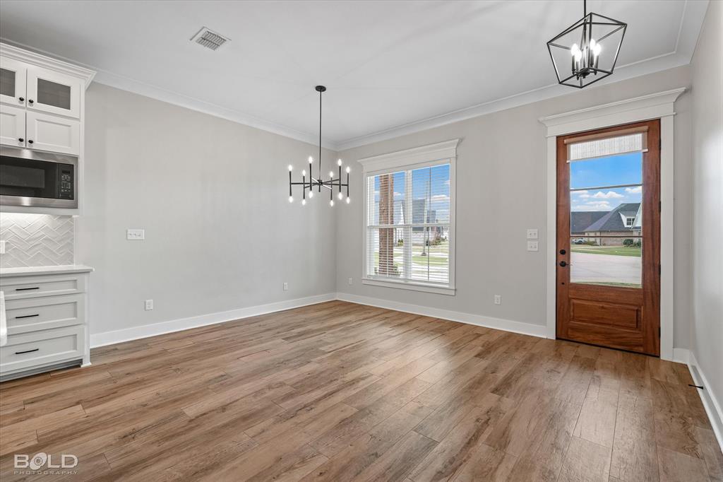 616 Meridian Way Benton, LA 71006 - Photo 13 of 40 a view of empty room with wooden floor and window