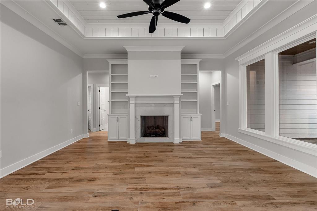 616 Meridian Way Benton, LA 71006 - Photo 15 of 40 a view of a livingroom with a fireplace a ceiling fan and window