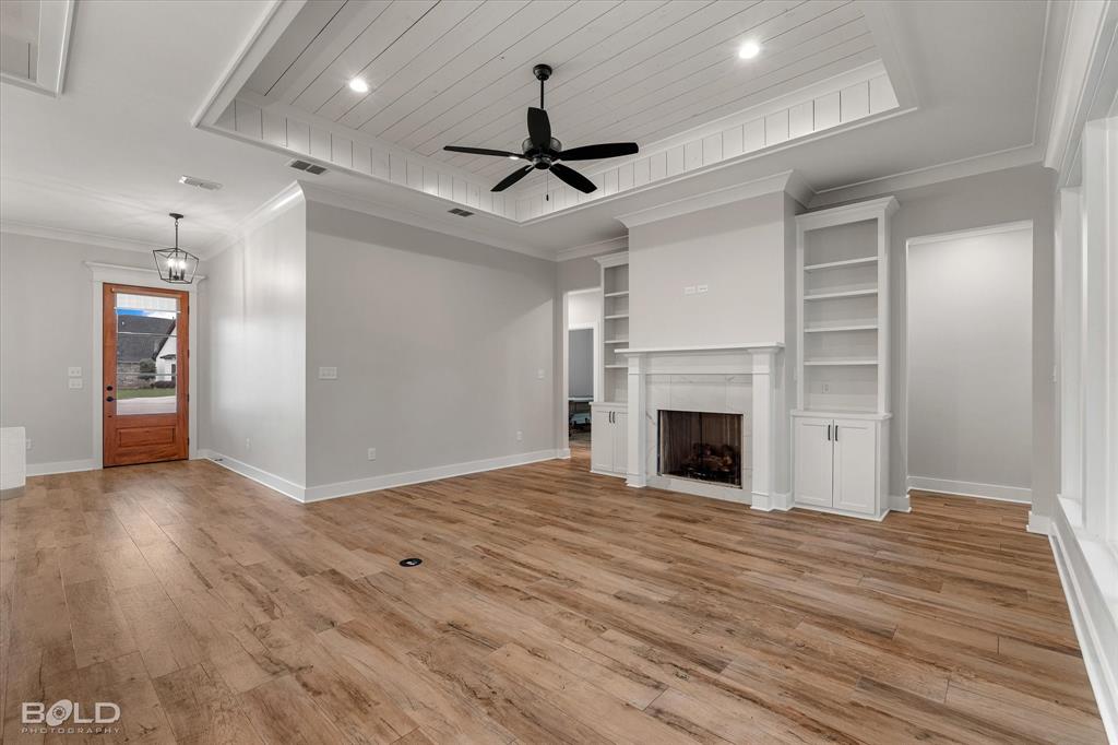 616 Meridian Way Benton, LA 71006 - Photo 16 of 40 a view of a livingroom with a fireplace a ceiling fan and window