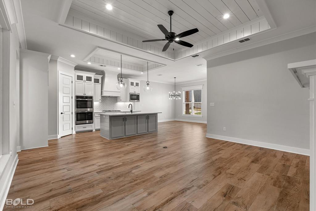 616 Meridian Way Benton, LA 71006 - Photo 37 of 40 a view of an empty room with a window and wooden floor