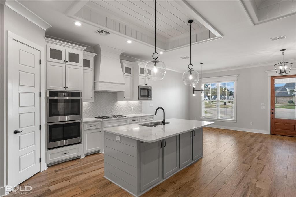 616 Meridian Way Benton, LA 71006 - Photo 17 of 40 a kitchen with kitchen island a sink stainless steel appliances and cabinets
