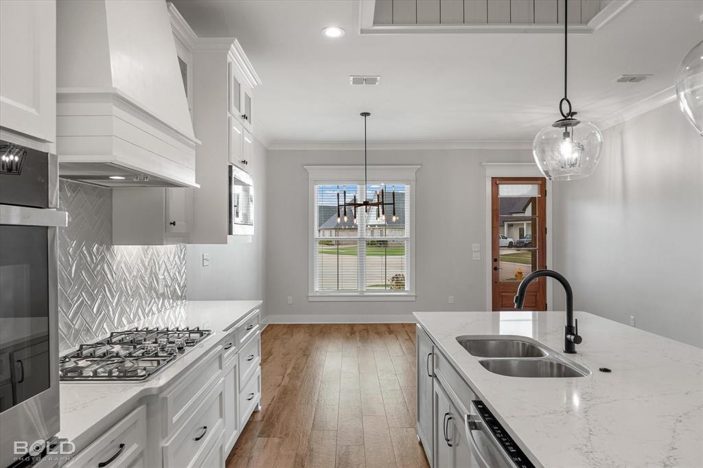 616 Meridian Way Benton, LA 71006 - Photo 18 of 40 a kitchen with sink cabinets and window
