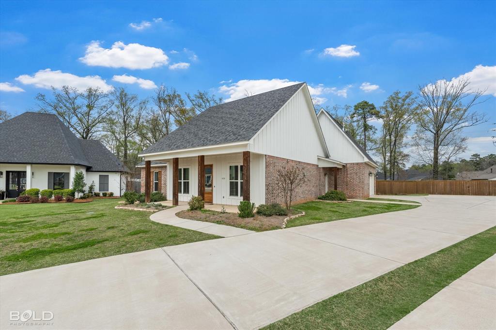 616 Meridian Way Benton, LA 71006 - Photo 2 of 40 a front view of a house with a yard
