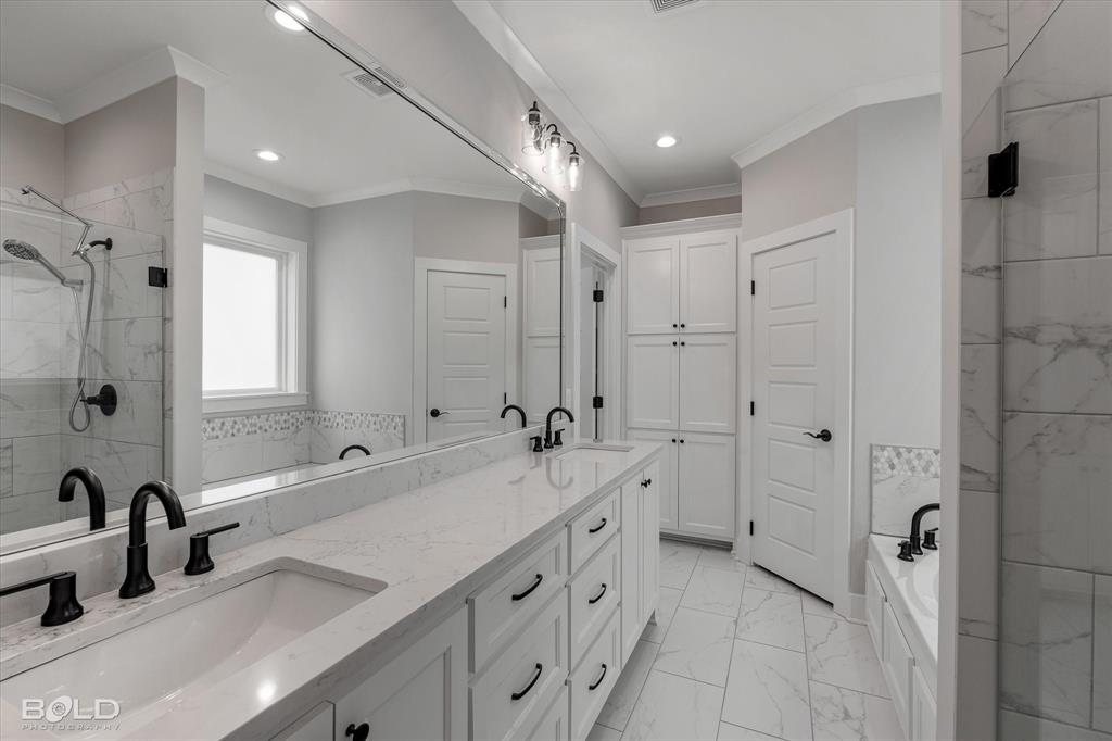 616 Meridian Way Benton, LA 71006 - Photo 21 of 40 a bathroom with a double vanity sink mirror double and shower