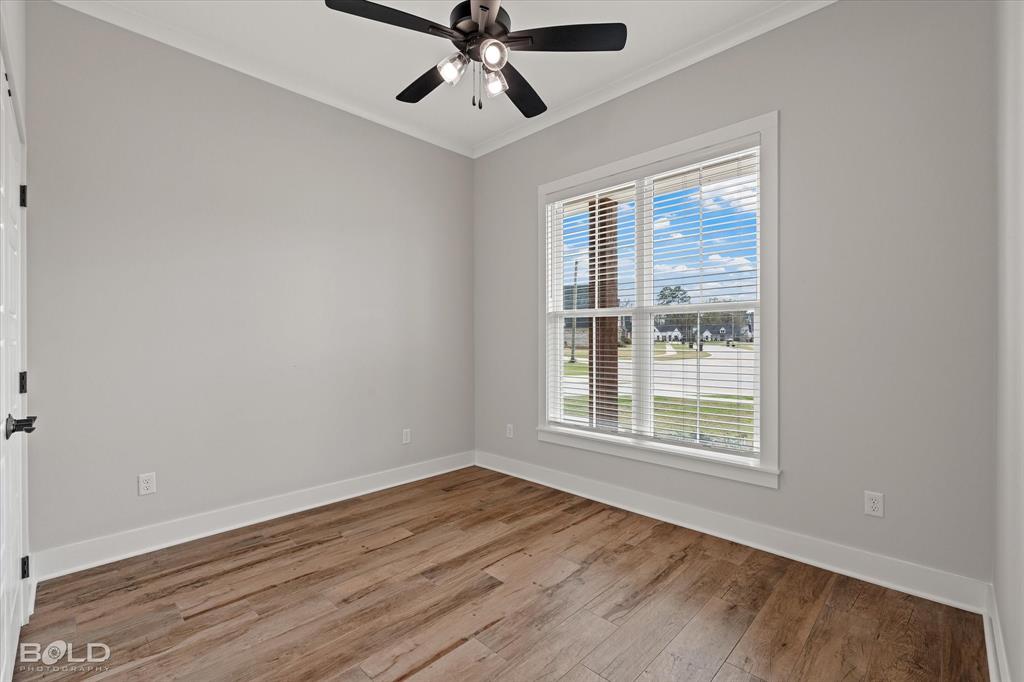 616 Meridian Way Benton, LA 71006 - Photo 28 of 40 an empty room with wooden floor fan and windows