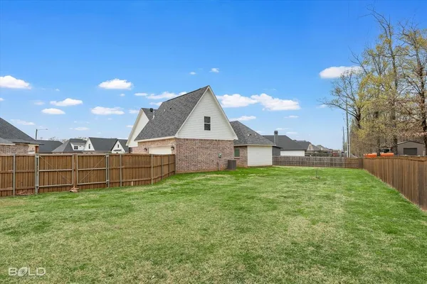 a view of a house with a yard and sitting area