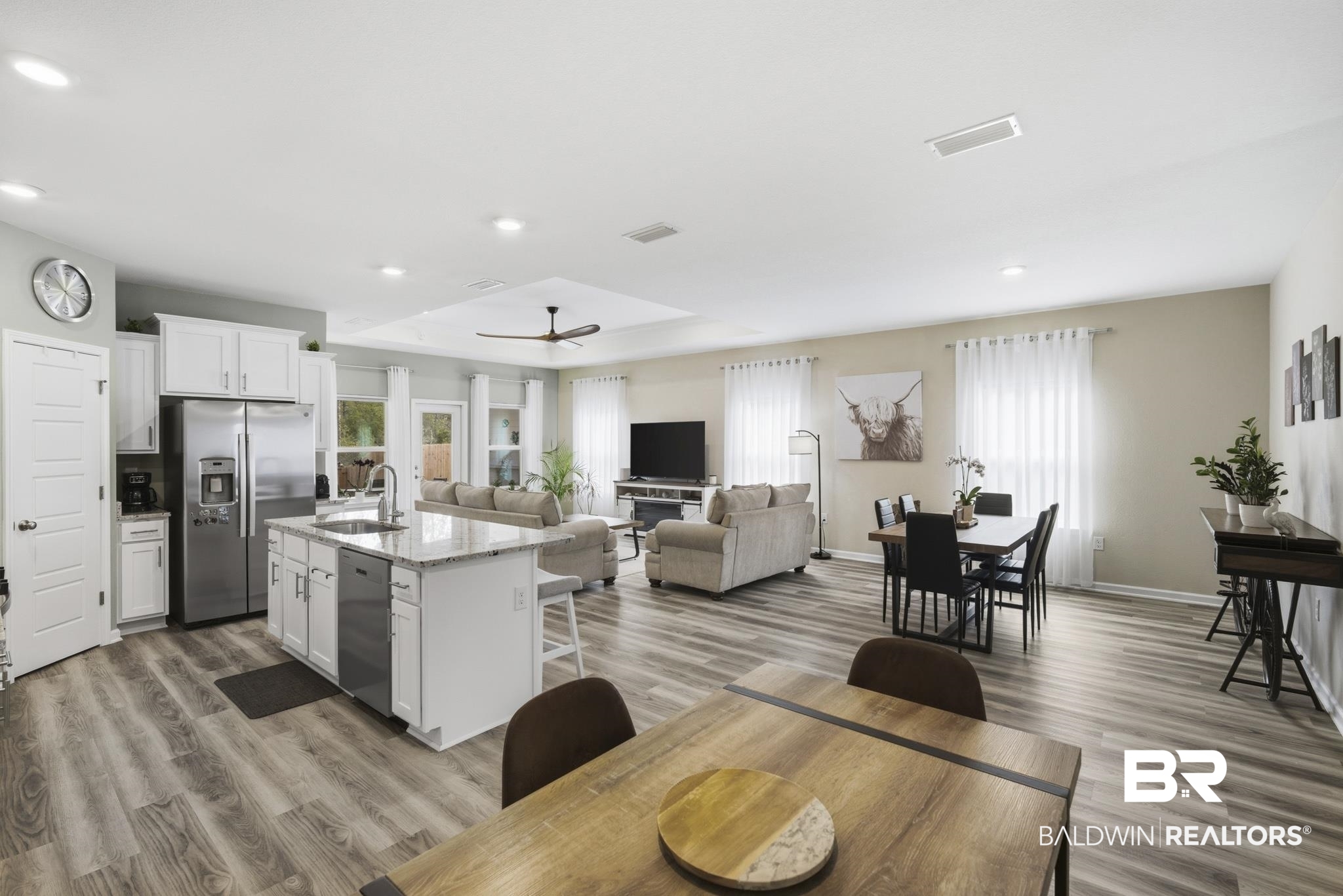 13887 Antler Hl Road Daphne, AL 36527 - Photo 50 of 50 Kitchen featuring white cabinets, open floor plan, stainless steel appliances, a kitchen island with sink, and light wood finished floors