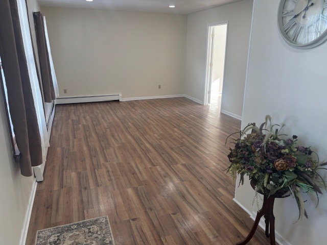 587 Phillips Circle Antioch, IL 60002 - Photo 3 of 20 a room with wooden floor and a potted plant