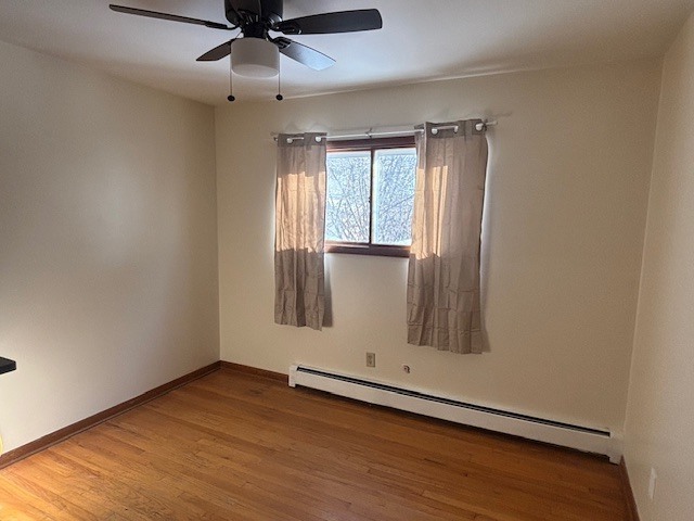 587 Phillips Circle Antioch, IL 60002 - Photo 10 of 20 an empty room with wooden floor fan and windows